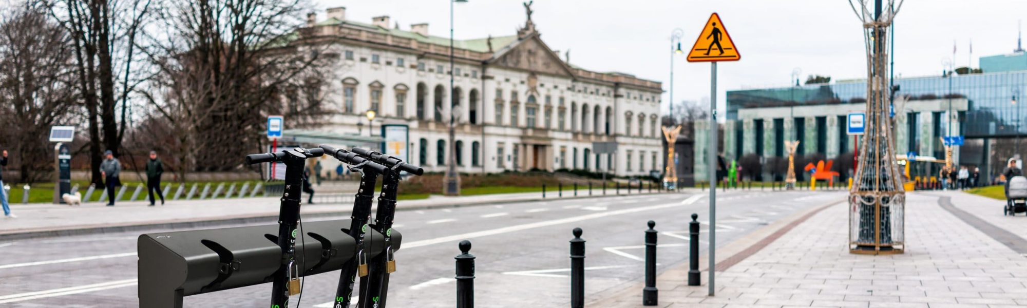 Warsaw, Poland - December 25, 2019: Lime electric scooter rental outside on street outdoors parked on street sidewalk in downtown with nobody in Warszawa